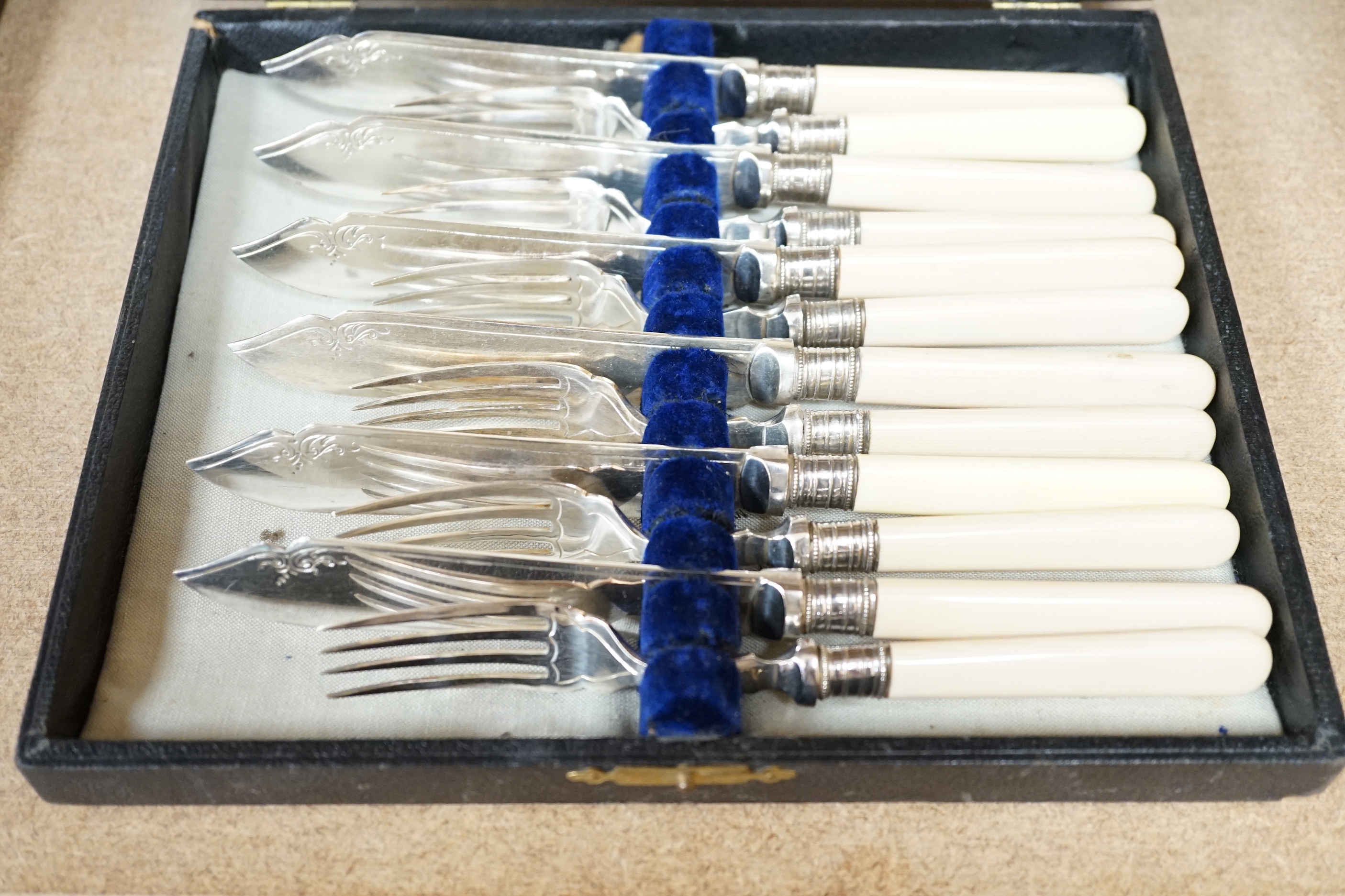 A group of assorted cased flatware comprising a set of six silver coffee spoons, Birmingham 1949, 100 grams, a silver fork and plated spoon christening set, fork 49 grams, a set of five Edwardian silver teaspoons and ton